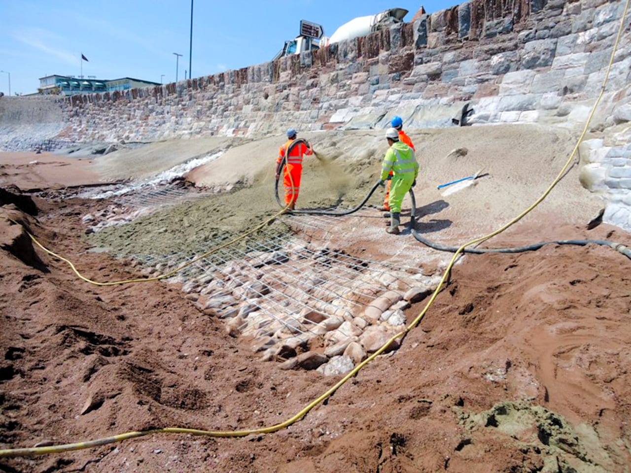 Sprayed concrete being applied to the face of Livermead Sea Wall