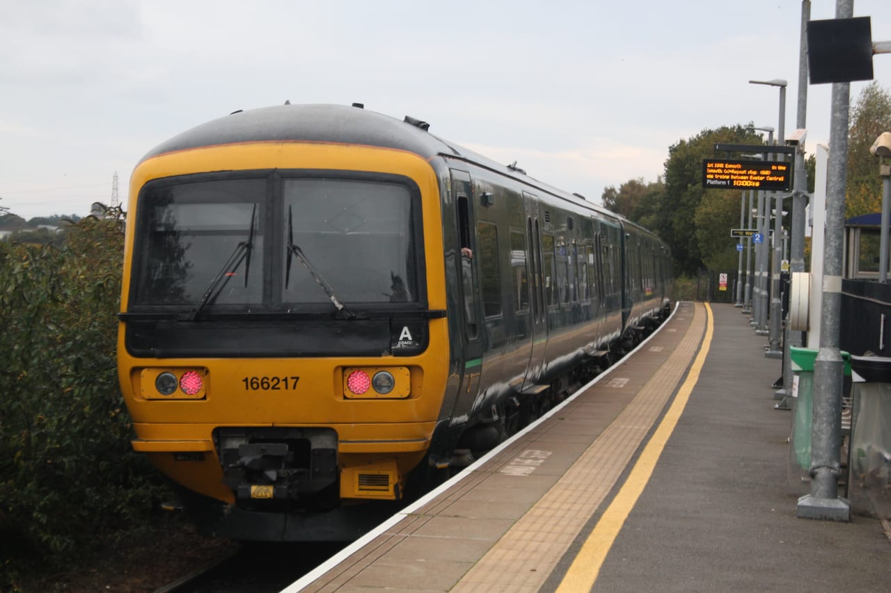 A train at the platform at Newcourt Station, Exeter, in 2025